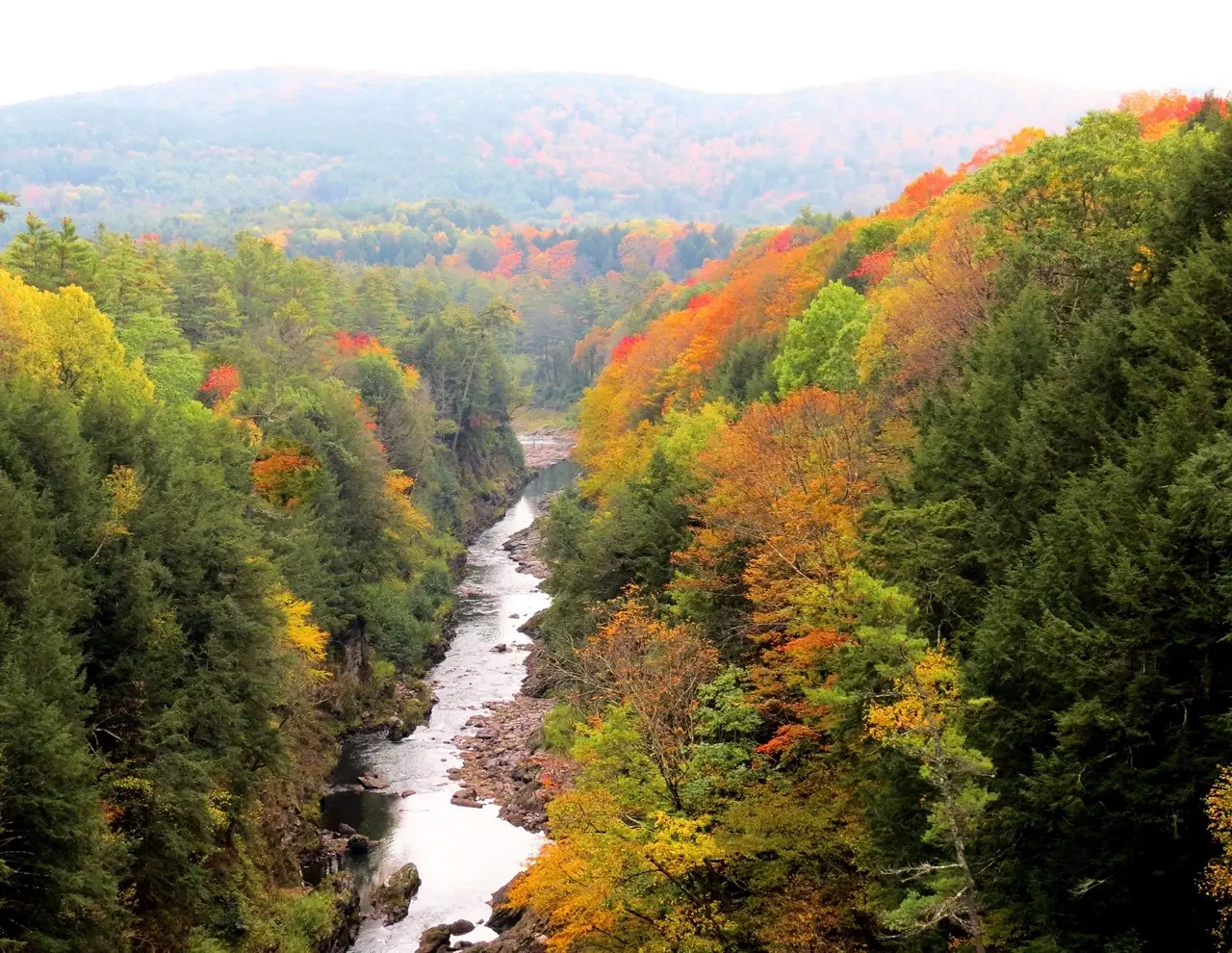 Fall foliage view of Vermont with a river