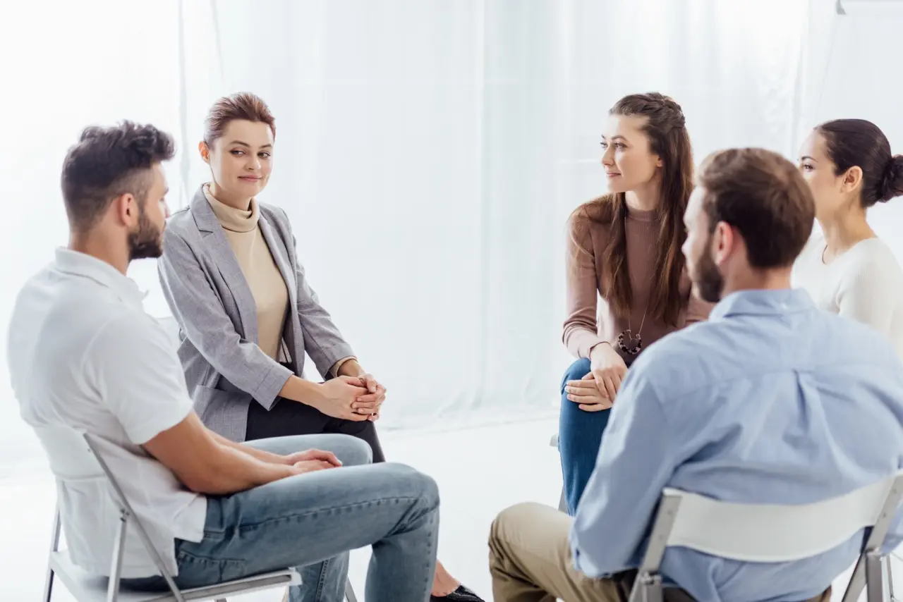 A group of men and women sitting in a circle during group therapy for OSFED treatment at Kahm Center